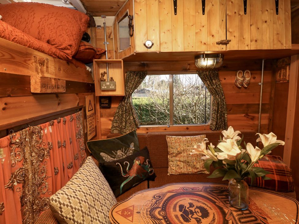 A living room with a table and sofa at Old Rosie in Grantham