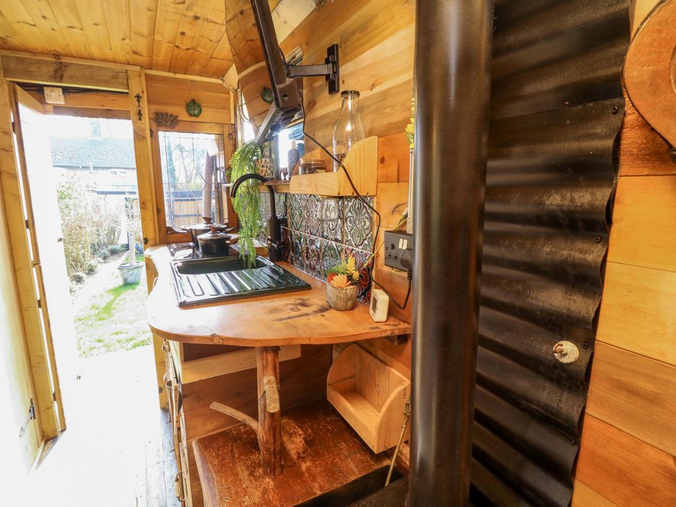 A kitchen with a sink and wood counter at Old Rosie in Grantham