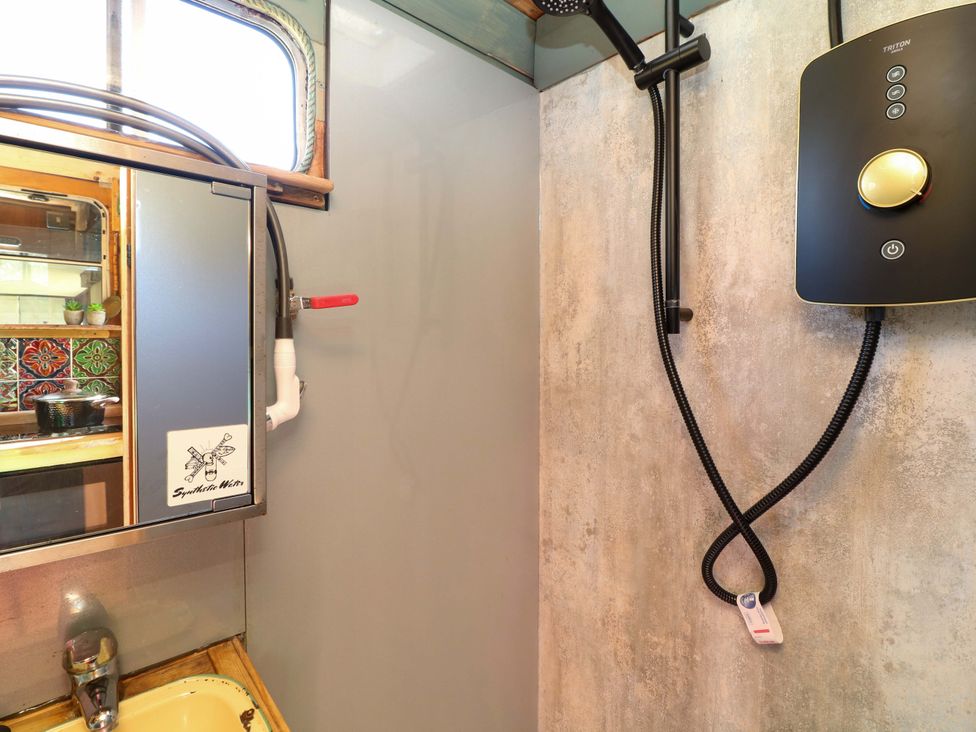 A bathroom with a shower unit and sink at Old Rosie in Grantham