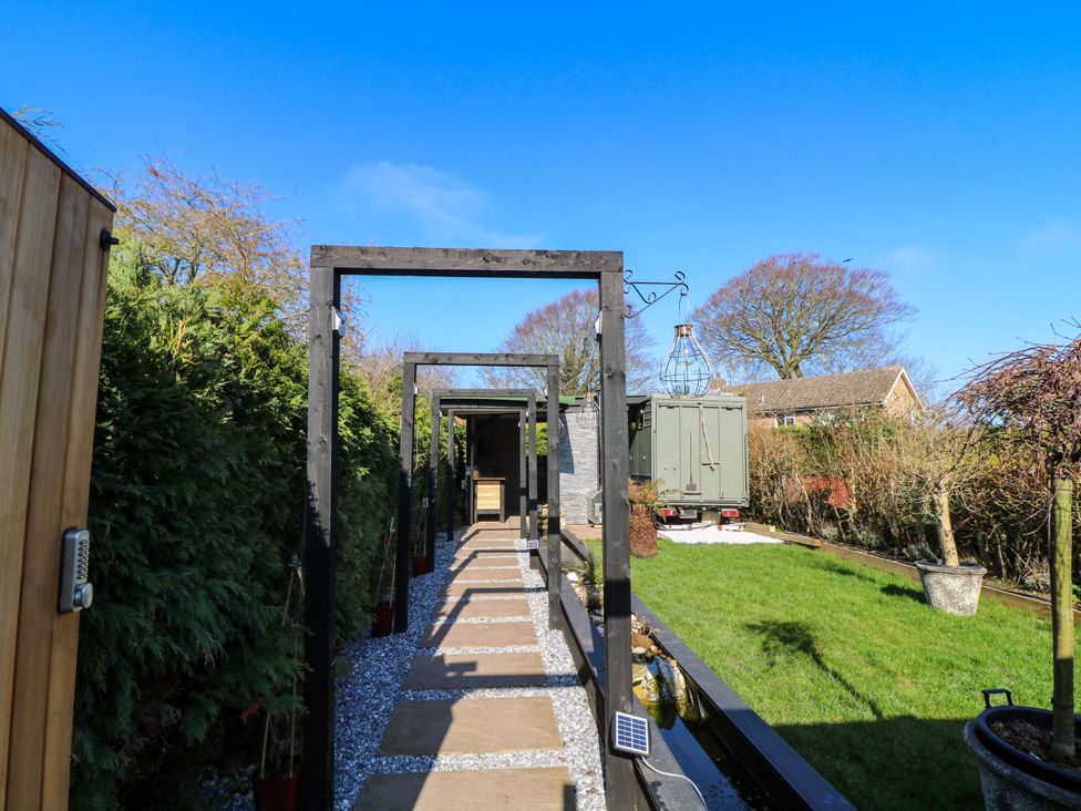 A garden pathway with outdoor structures at Old Rosie in Grantham