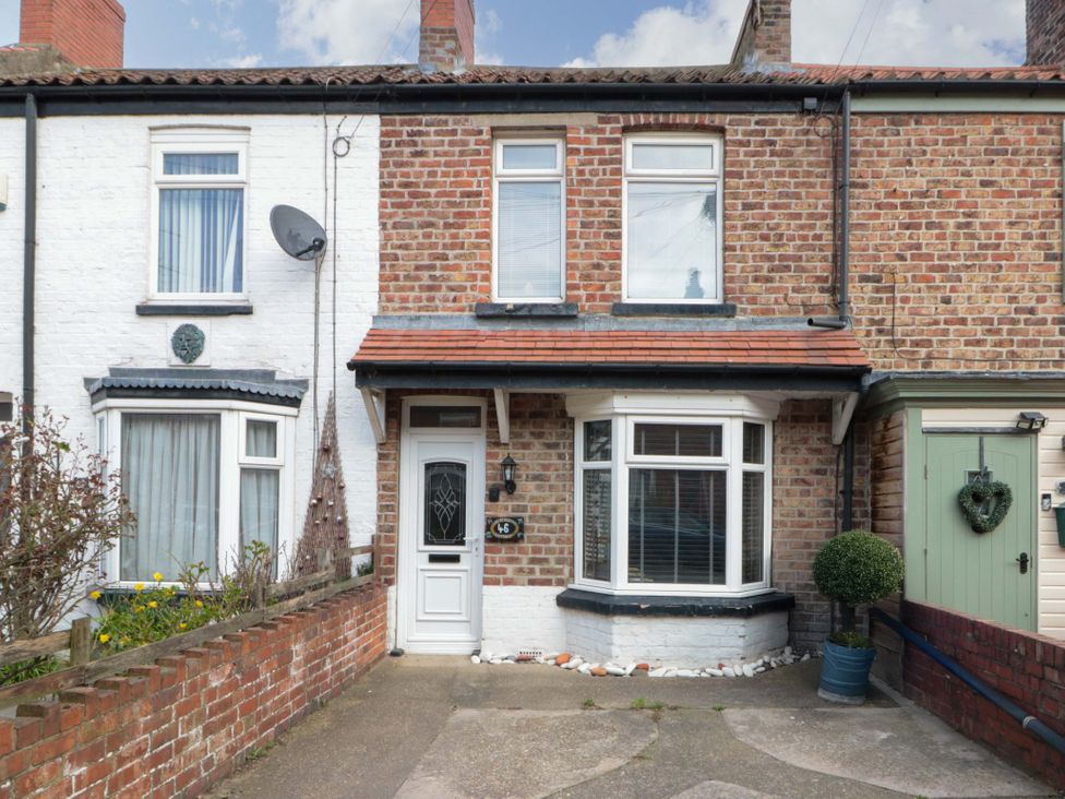 A brick house with a white door and windows at 46 Nelson Street in Bridlington