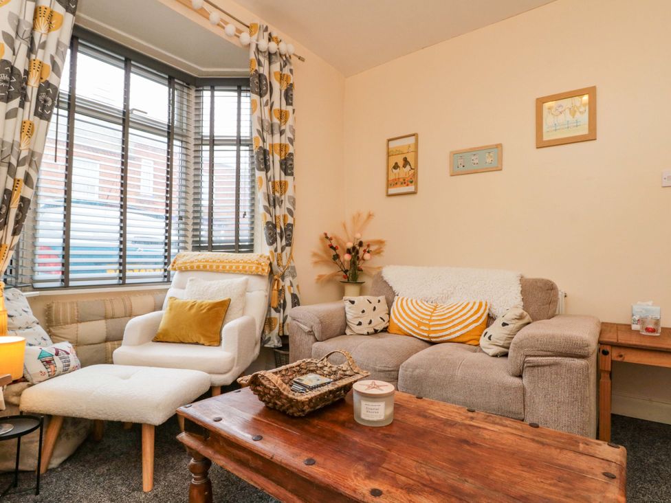 A living room with an armchair and coffee table at 46 Nelson Street in Bridlington