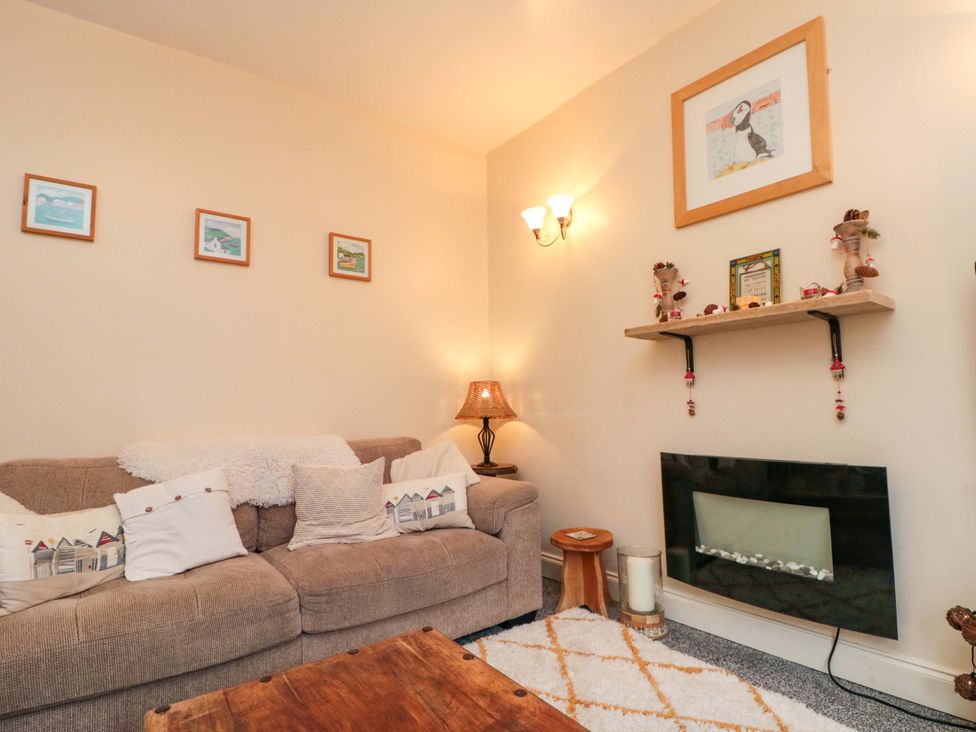 A living room with a sofa and fireplace at 46 Nelson Street in Bridlington