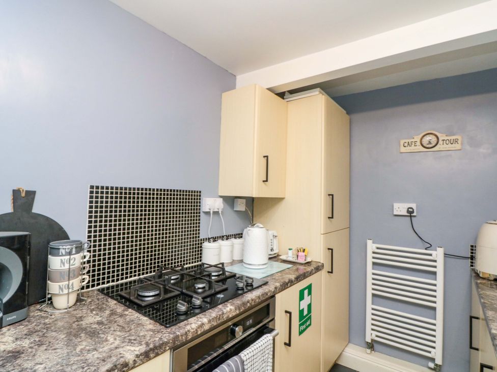 A kitchen with cabinets and a gas stove at 46 Nelson Street in Bridlington