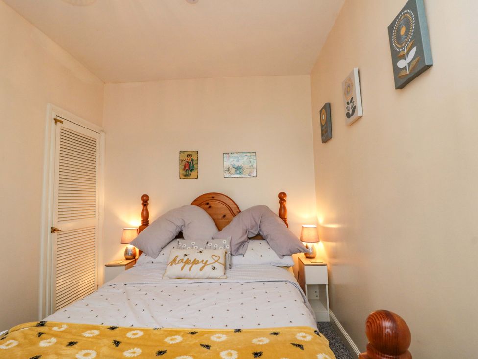 A bedroom with a bed and wall art at 46 Nelson Street in Bridlington