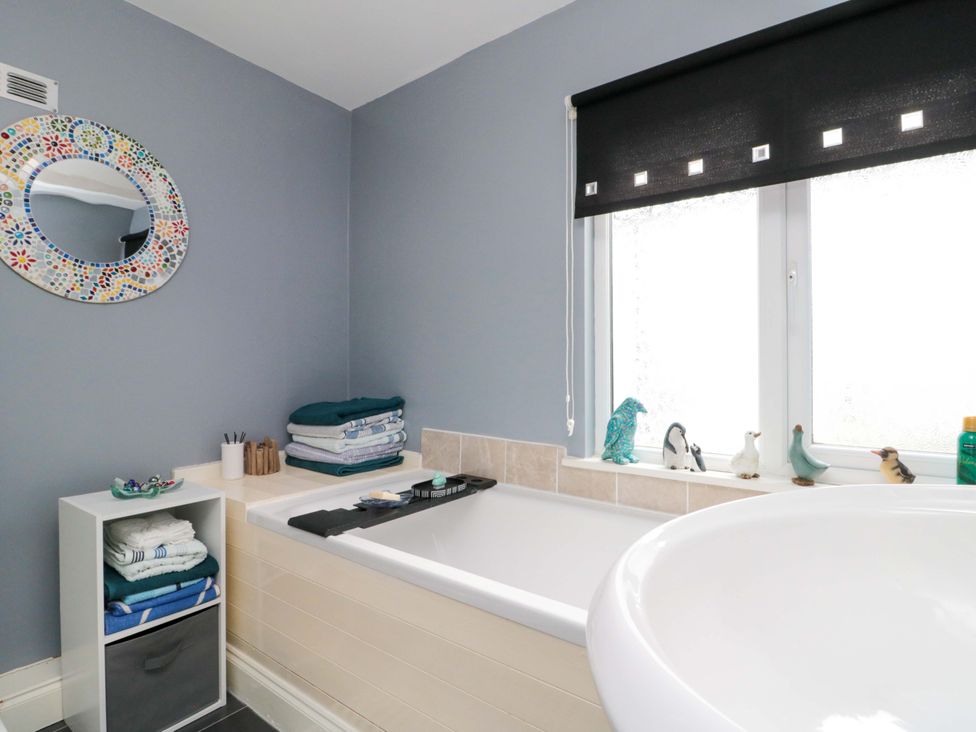 A bathroom with a bathtub and towels at 46 Nelson Street in Bridlington