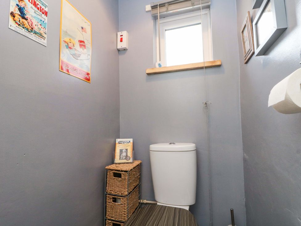 A bathroom with a toilet and storage baskets at 46 Nelson Street in Bridlington