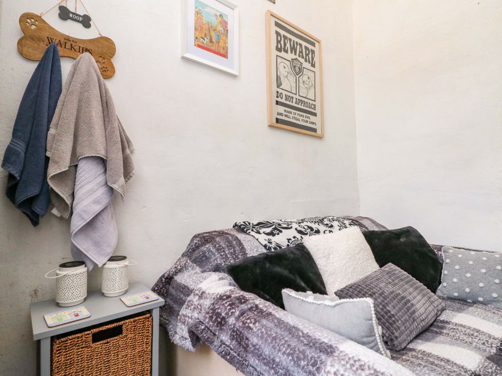 A small room with a sofa, cushions, and wall art at 46 Nelson Street, Bridlington