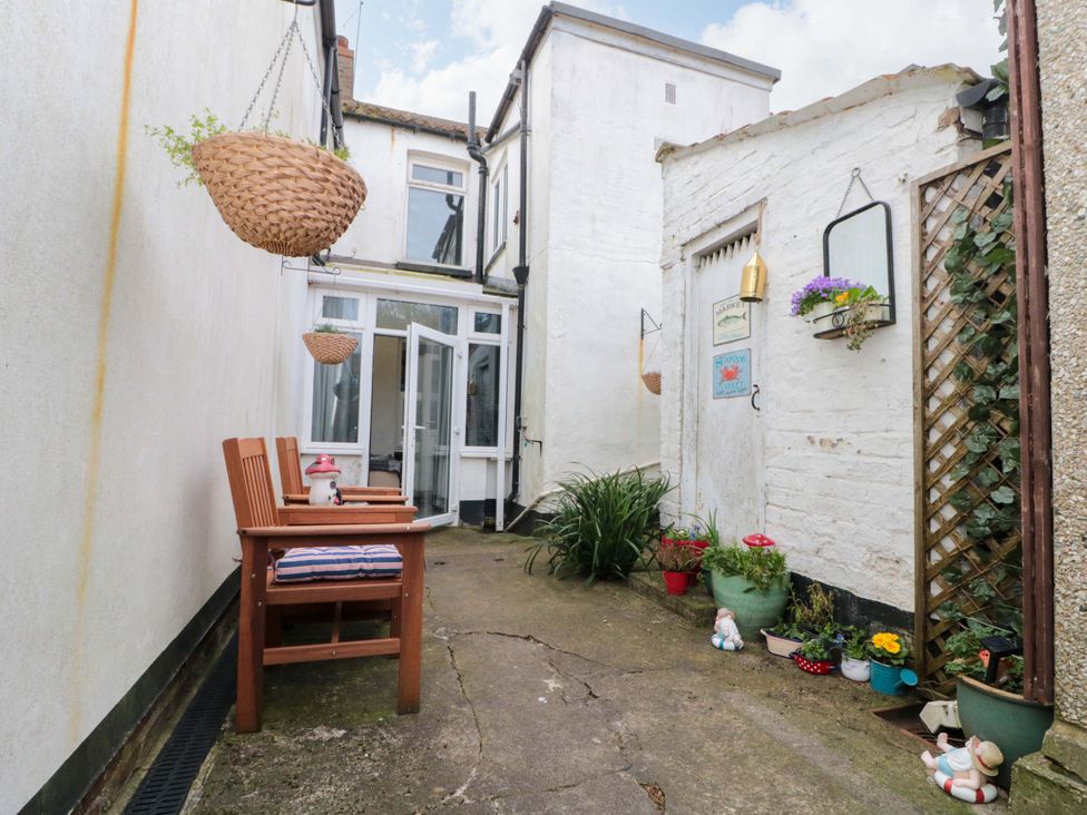 An outdoor path with chairs and plants at 46 Nelson Street in Bridlington