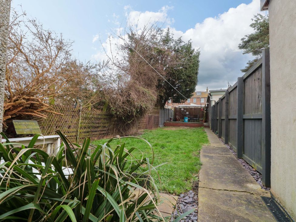 A garden with grass and a pathway at 46 Nelson Street in Bridlington