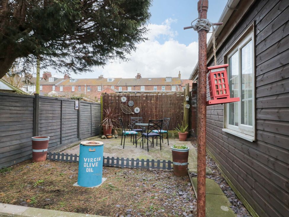 A garden with chairs, a table, and plants at 46 Nelson Street in Bridlington