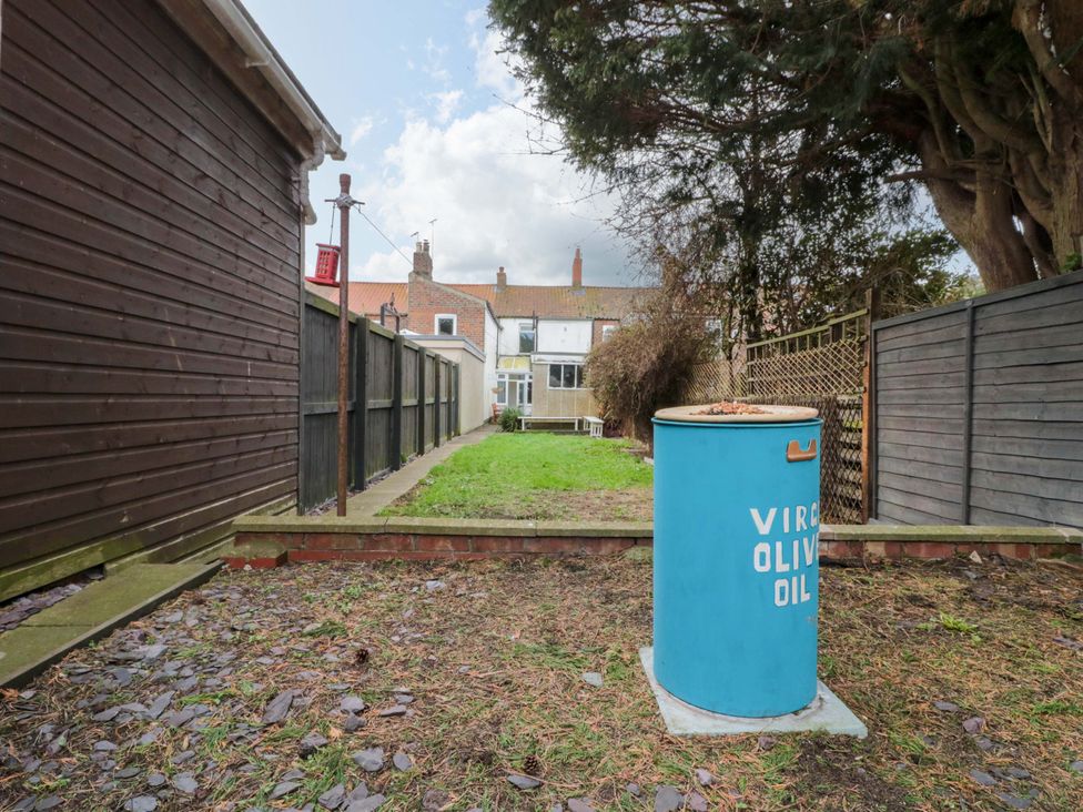 A garden with an oil drum and a fence at 46 Nelson Street in Bridlington