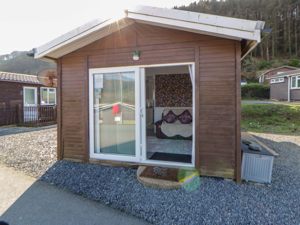 A cabin with a door and window at The Comfort Den near Aberystwyth