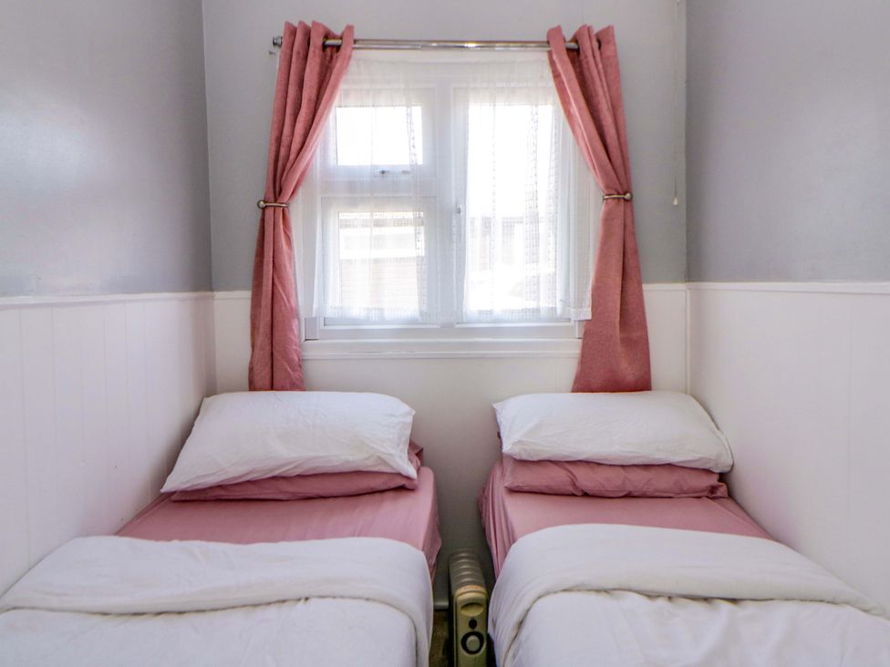 A bedroom with two single beds at The Comfort Den near Aberystwyth