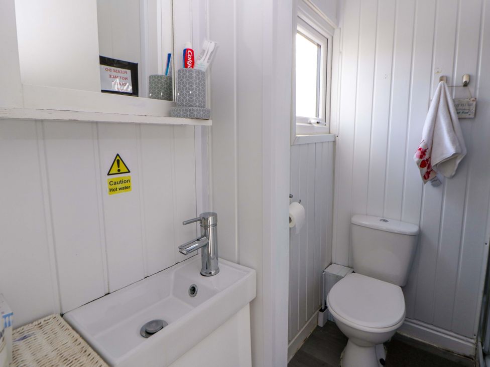 A bathroom with a sink and toilet at The Comfort Den near Aberystwyth