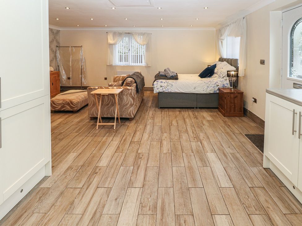 A living room with bed and sofa at Annexe @ Meadows Farm Swansea