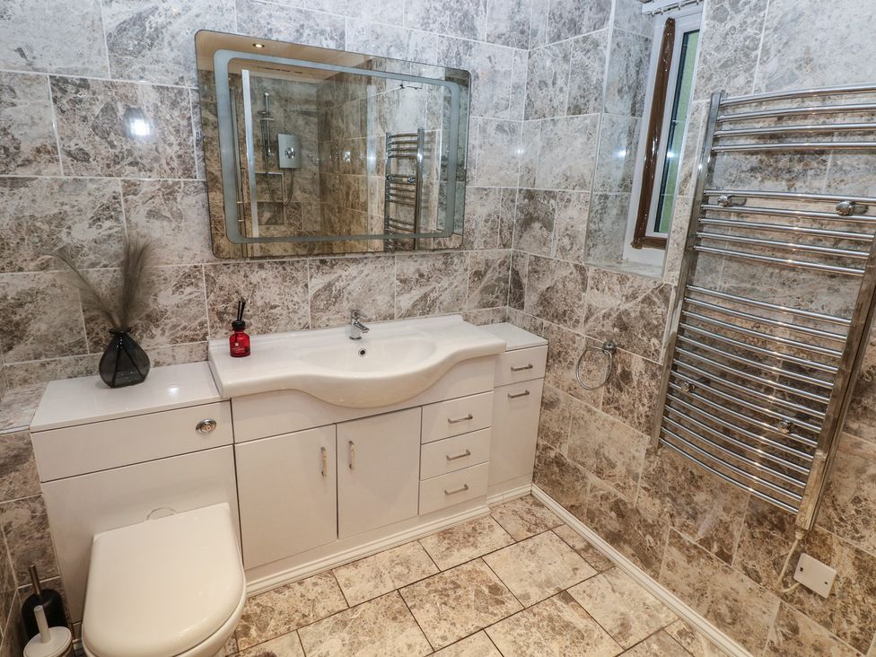 A bathroom with a sink and toilet at Annexe @ Meadows Farm in Swansea