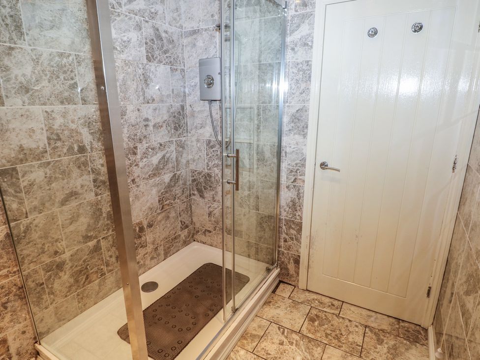 A shower area with tiled walls at Annexe @ Meadows Farm Swansea