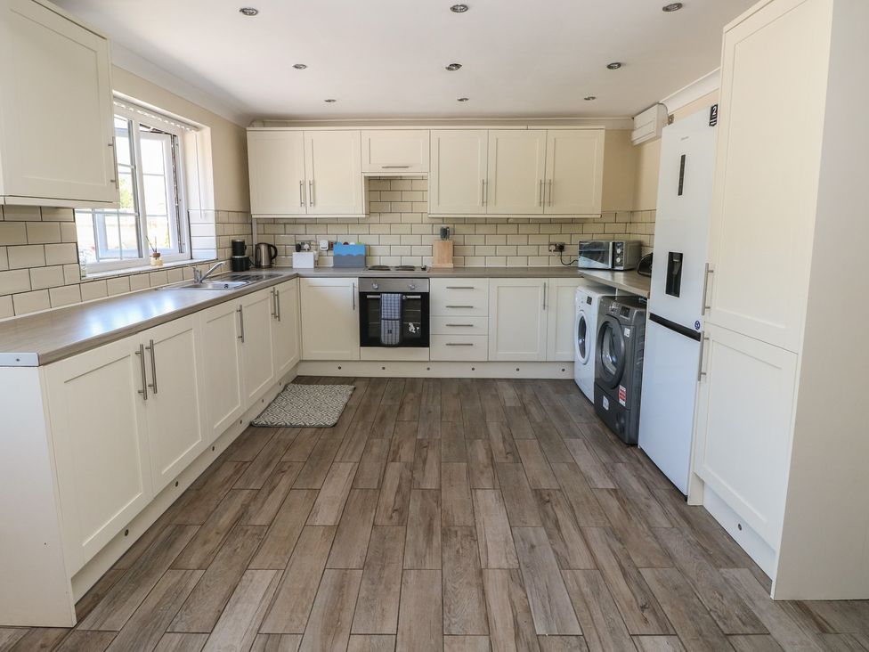 A kitchen with cabinets and appliances at Annexe @ Meadows Farm in Gorseinon