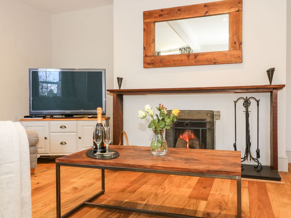 A living room with a television and a coffee table at The Old Post Office in York