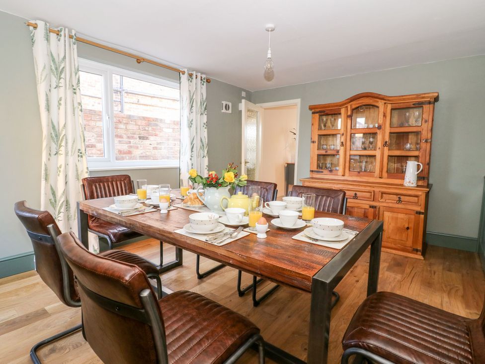 A dining room with a wooden table and chairs at The Old Post Office in York