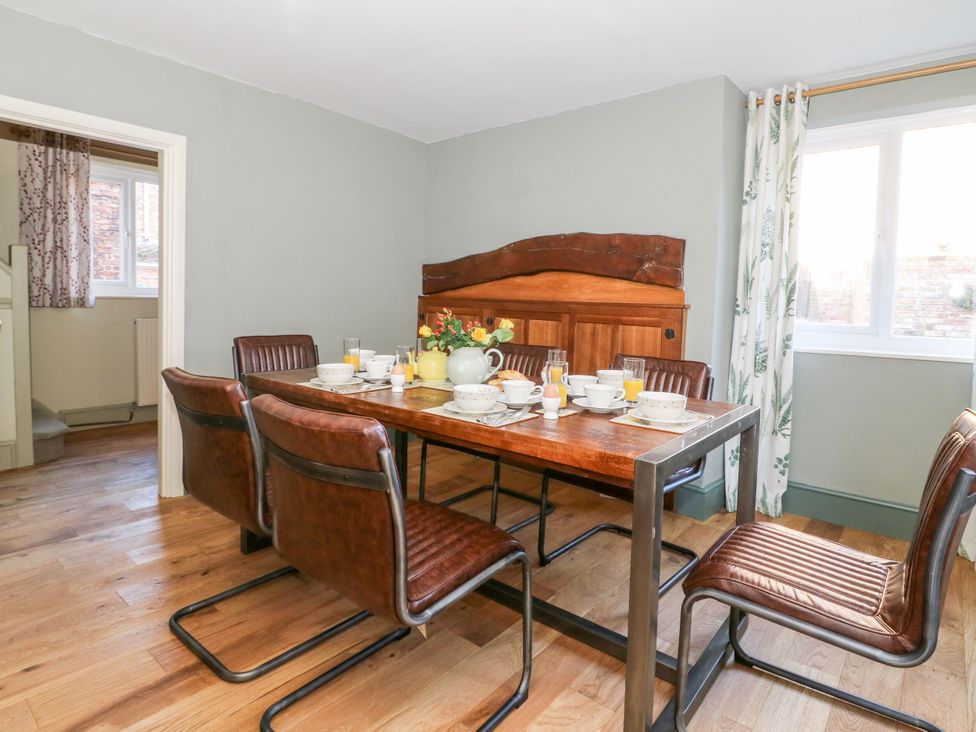 A dining room with a wooden table set for a meal at The Old Post Office in York