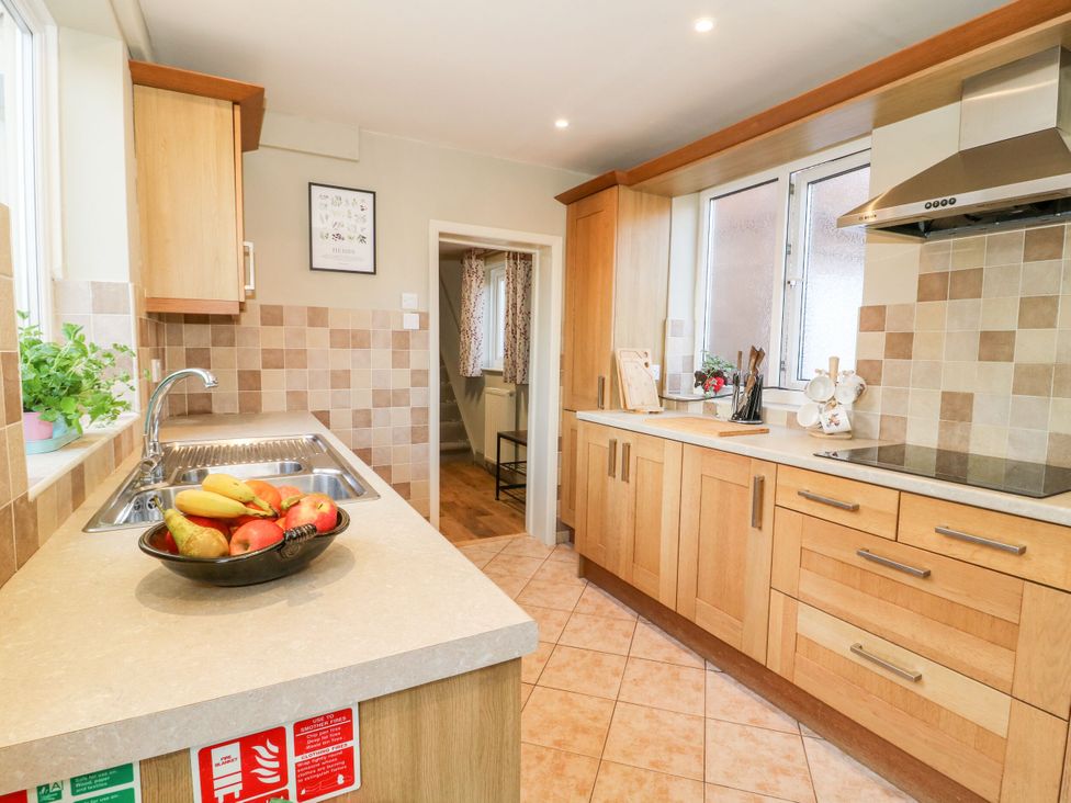 A kitchen with wooden cabinets and a fruit bowl at the Old Post Office in York