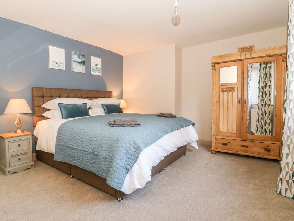 A bedroom with a bed and wardrobe at The Old Post Office in York