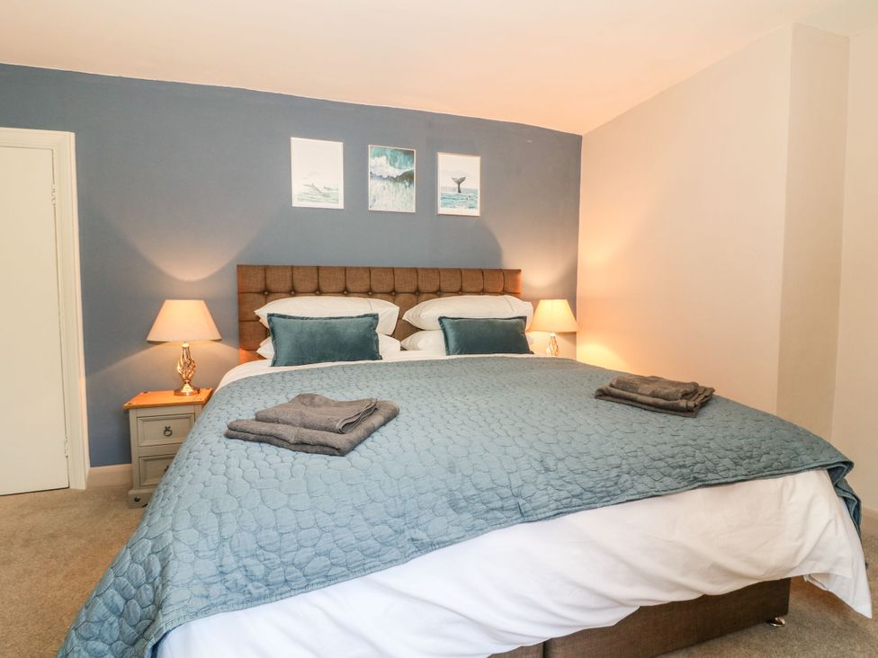 A bedroom with a large bed and nightstand at The Old Post Office York