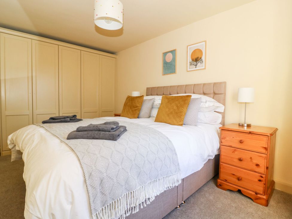 A bedroom with a bed and wardrobe at The Old Post Office in York