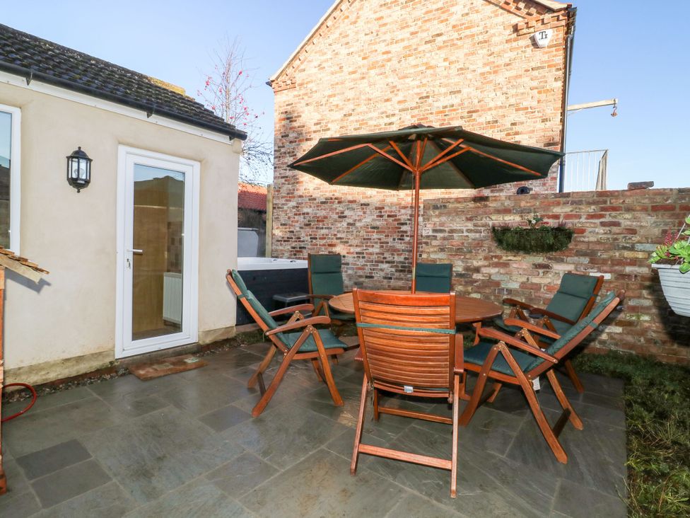 An outdoor seating area with a table and chairs at The Old Post Office in York