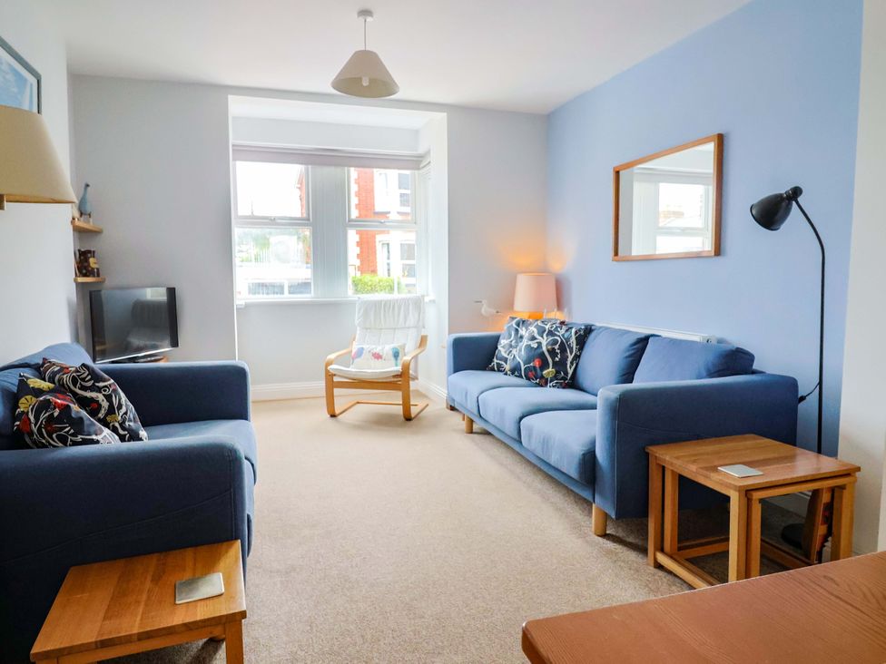 A living room with two sofas and a television at 4 Peaslands Road Sidmouth