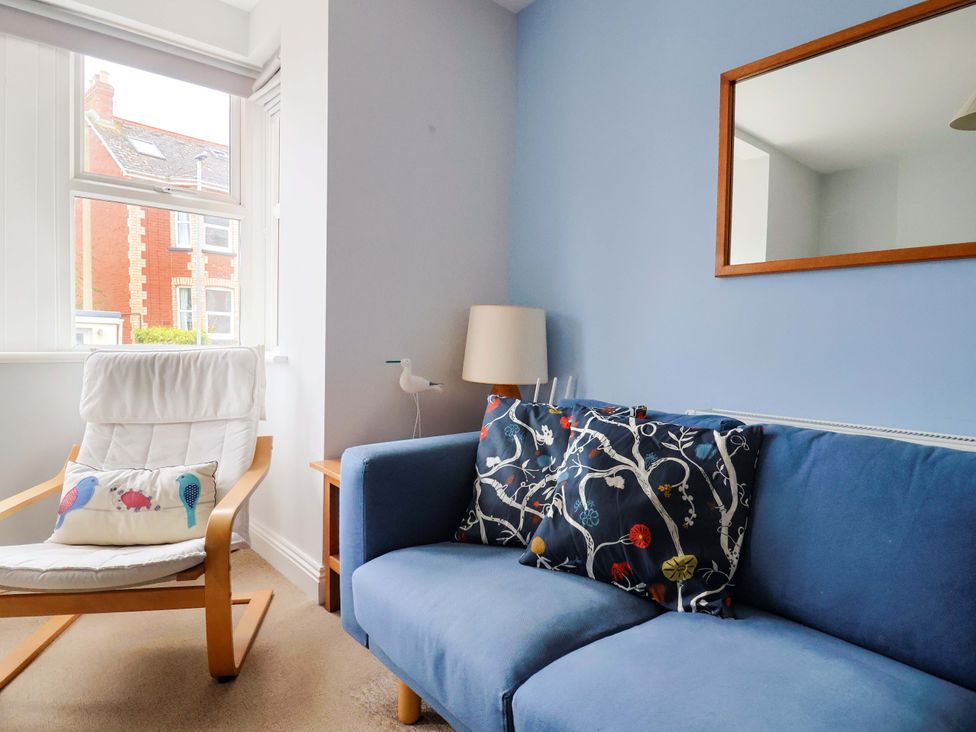 A living room with a sofa and armchair at 4 Peaslands Road Sidmouth