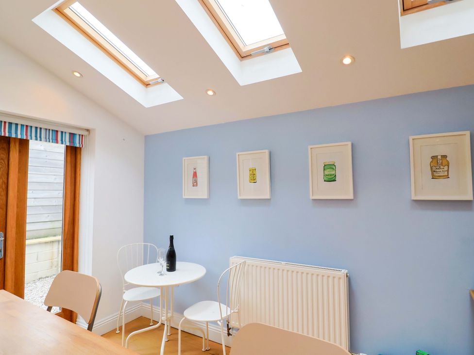A dining room with a table and chairs at 4 Peaslands Road in Sidmouth