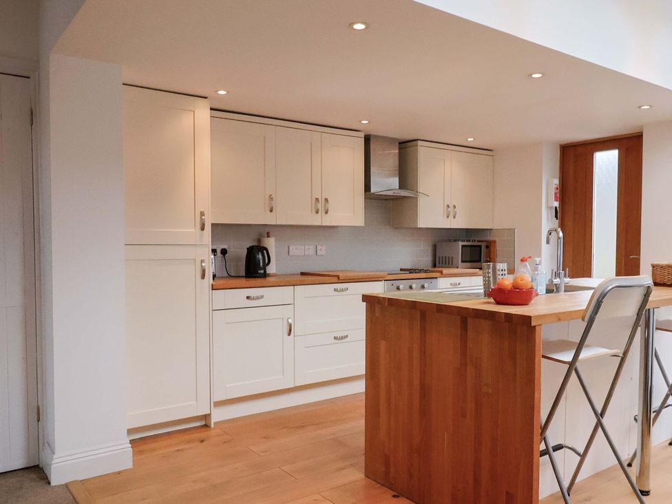 A kitchen with cabinets, sink, and fruit bowl at 4 Peaslands Road in Sidmouth