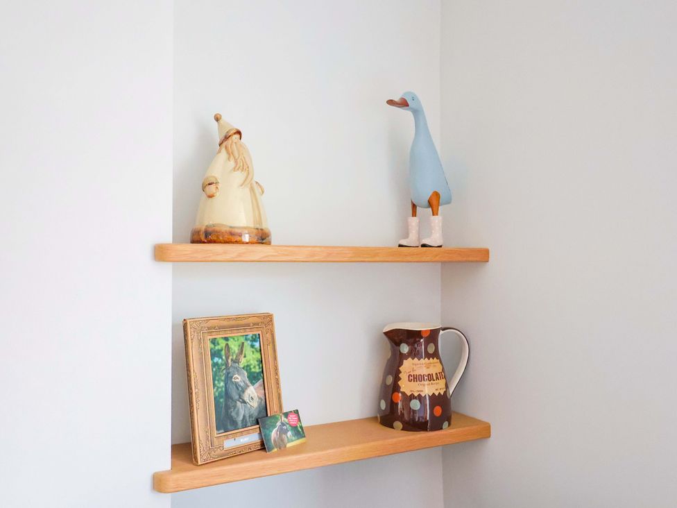 A shelf with decorative items and a photo frame at 4 Peaslands Road Sidmouth