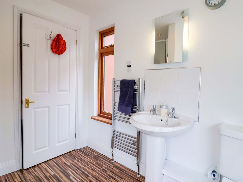 A bathroom with a sink and towel rail at 4 Peaslands Road Sidmouth