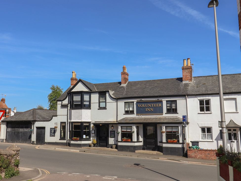 A building exterior of Volunteer Inn on a street in Sidmouth