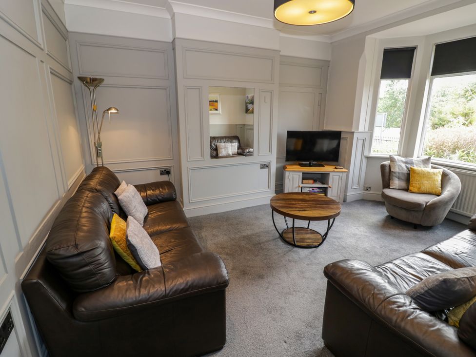 A living room with a sofa, coffee table and television at 141 Barnards Green Road, Barnard's Green, Malvern
