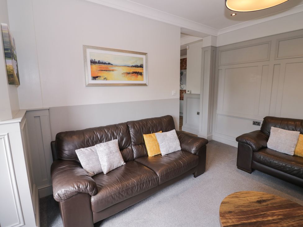 A living room with a sofa and painting at 141 Barnards Green Road, Barnard's Green, Malvern