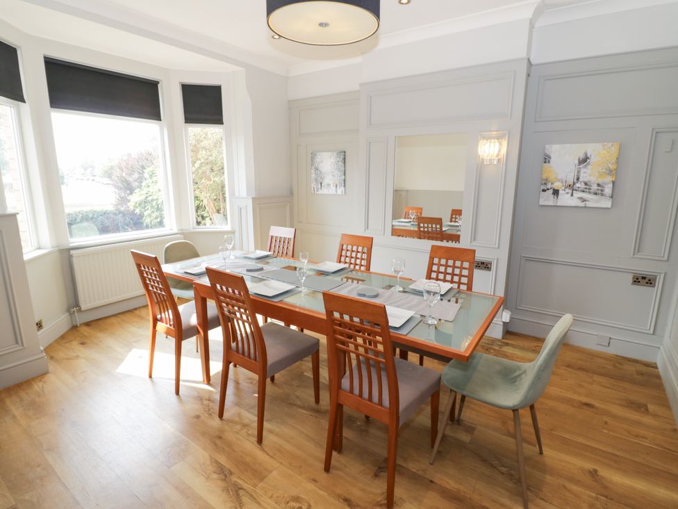 A dining room with a rectangular table and chairs at 141 Barnards Green Road, Barnard's Green, Malvern