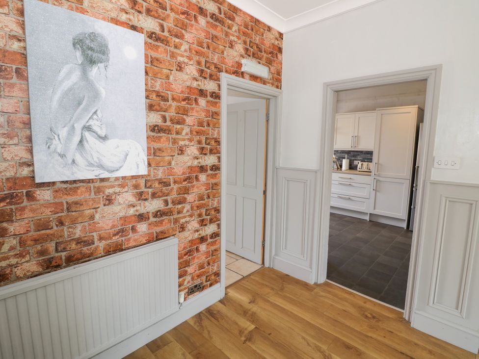 A hallway with a doorway to the kitchen at 141 Barnards Green Road, Barnard's Green, Malvern