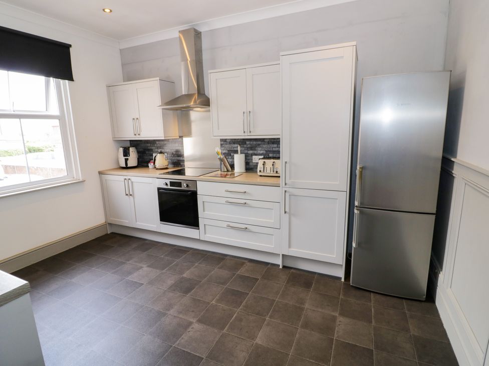 A kitchen with appliances including a fridge and oven at 141 Barnards Green Road, Barnard's Green, Malvern