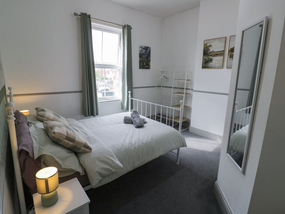 A bedroom with a bed and a shelf at 141 Barnards Green Road, Barnard's Green, Malvern
