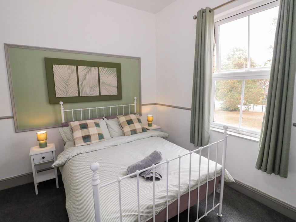 A bedroom with a bed and a bedside table at 141 Barnards Green Road, Barnard's Green, Malvern