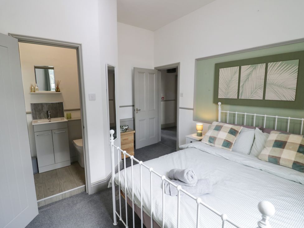 A bedroom with a bed and bathroom at 141 Barnards Green Road in Barnard's Green, Malvern