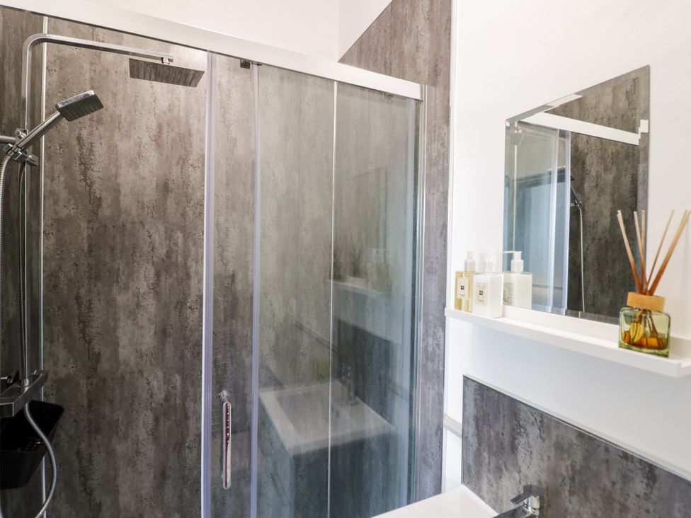 A bathroom with a shower and sink at 141 Barnards Green Road, Barnard's Green, Malvern