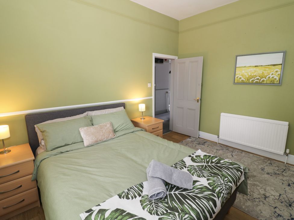 A bedroom with a bed and bedside tables at 141 Barnards Green Road, Barnard's Green, Malvern