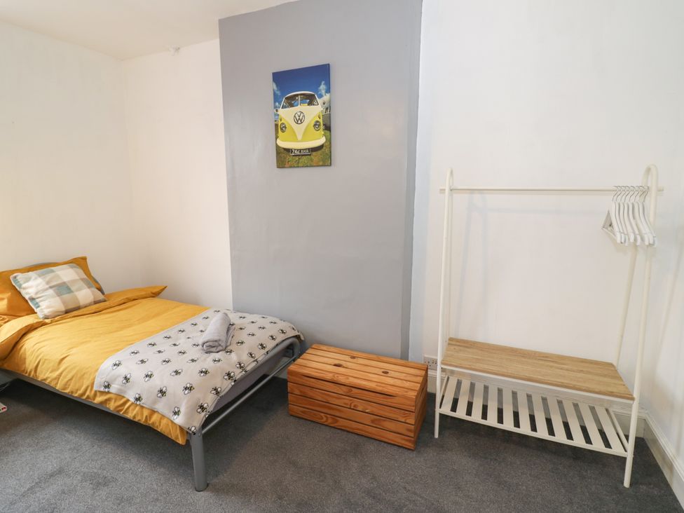 A bedroom with a bed and a clothes rack at 141 Barnards Green Road Barnard's Green, Malvern