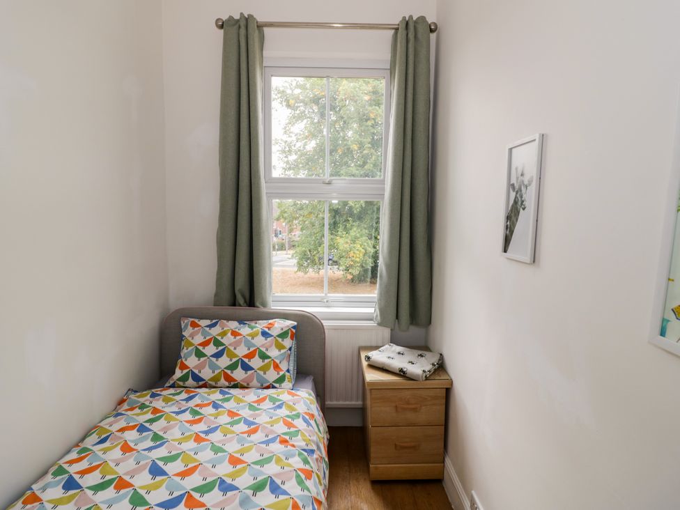 A bedroom with a bed and a window at 141 Barnards Green Road, Barnard's Green, Malvern